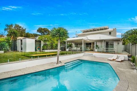 Private backyard with alfresco dining, BBQ, fenced pool, and in-ground trampoline
