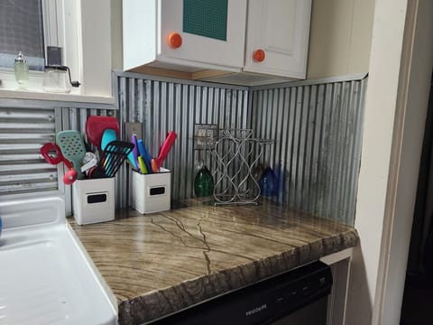 dishwasher with concrete countertop and wine holder and glasses utensils holder