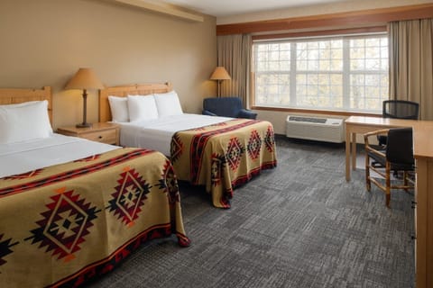 Unwind in a bright room with plush beds and calm views