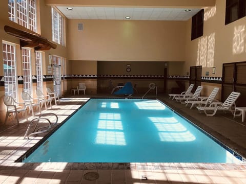 Dive into sunlit laps in the inviting indoor pool.