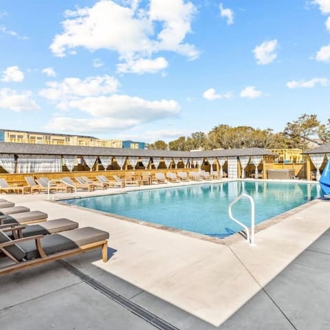 Resort-style heated community pool with plenty of lounge seating.