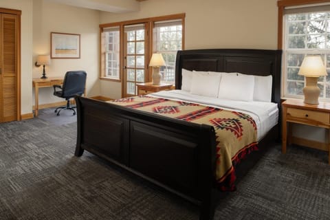 Recharge in a serene room with desk, light, and comfort.