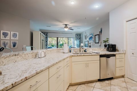 A fully equipped kitchen w/stove top oven, dishwasher, refrigerator & microwave.