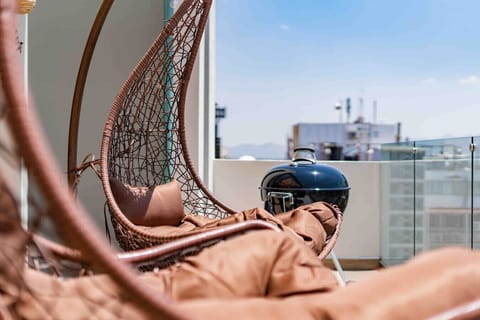 Comfortable swing chairs on the rooftop, perfect for chilling.