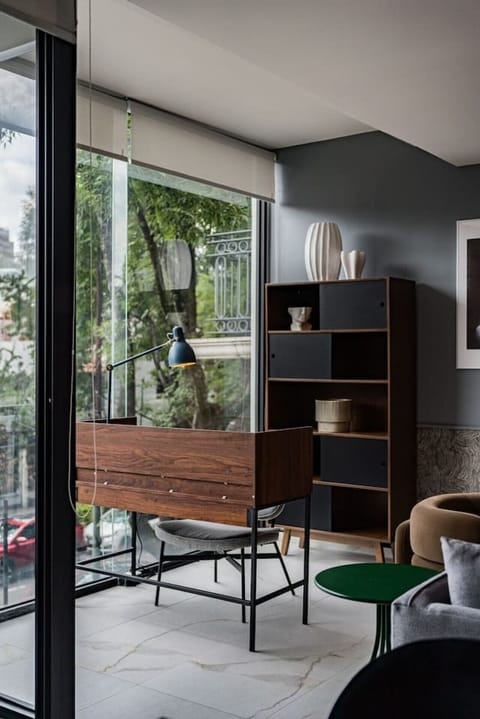 Well-lit coworking area designed for productivity, complete with a spacious desk and vibrant views through the large windows.