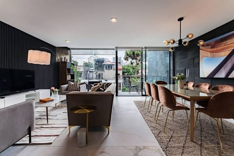 Elegant, sunlit dining and living space with floor-to-ceiling windows