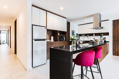 Modern kitchen island with striking bar stools, great for a quick breakfast or socializing.
