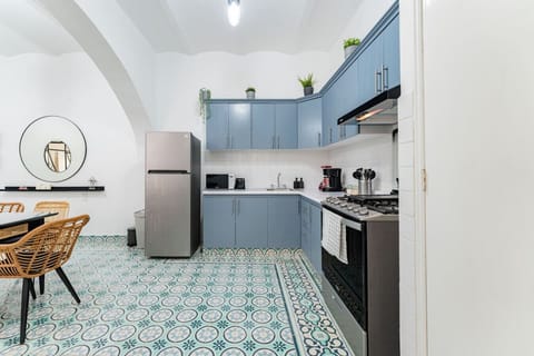 Modern kitchen with blue cabinets.