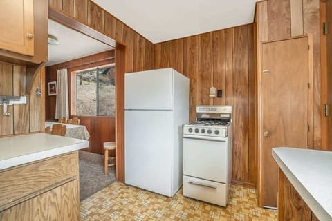 Kitchen with fridge freezer combo and gas stove.