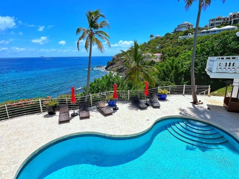 Lounge by the pool with breathtaking island scenery all around.
