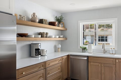 Dishwasher, stove, coffee, toaster, silverware, cutlery, plates, bowls, etc.