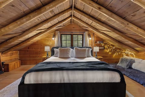 The spacious loft has a comfortable King-sized bed, 2 chairs and floor bed.