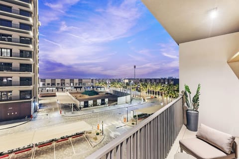 Balcony Bliss: Sip your morning coffee with stunning views of palm-lined streets and vibrant skies!