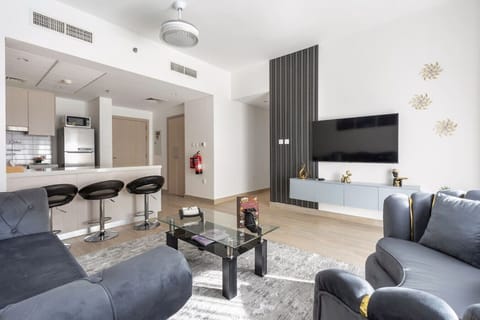 Living Room: Stylish space to unwind with modern decor, plush seating, and a view of the kitchen!