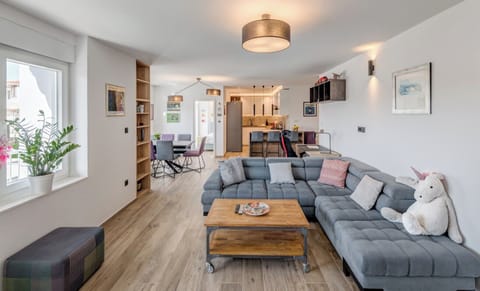 Living area with access to balcony and sofa bed for one guest.