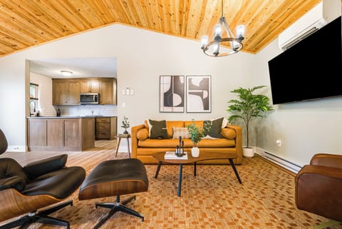 Relax with leather sofa, mid-century chairs & décor—comfort and style combined.