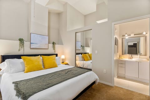 You feel enveloped in comfort as you relax on the queen bed, surrounded by a room designed for tranquility.