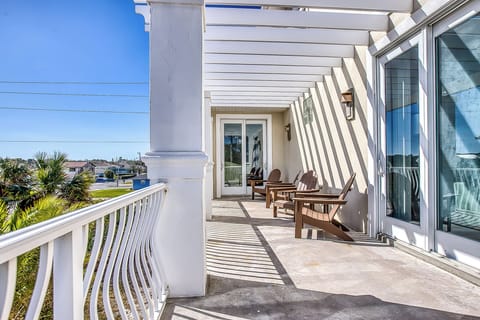 The second-floor balcony, accessible from the primary bedroom and one other bedroom, offers breathtaking sunrise and sunset views, making it a perfect spot to relax and soak in the beauty of the coast.