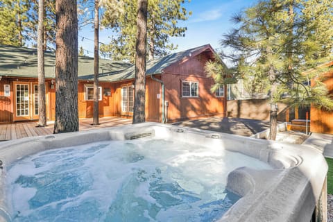Private outdoor hot tub, surrounded by tall pines, perfect for relaxing under the trees after a day of adventure—enjoy peaceful forest views, fresh air, and a truly rejuvenating stay.