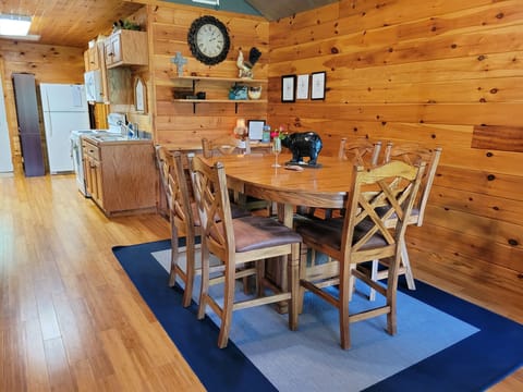 The tall dining table is perfect for cozy meals, games, or a workspace.