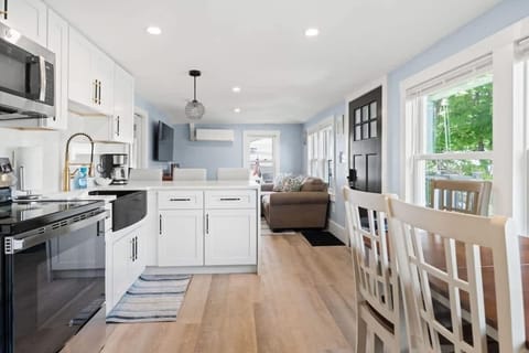 Cook and dine in style with a waterfall island and chairs in this bright, open-concept kitchen designed for entertaining.