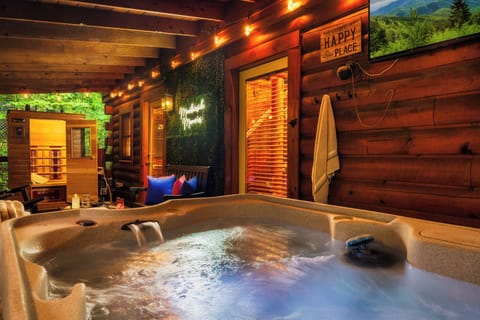 Relax outdoors with hot tub, sauna, Roku TV, and family seating area.