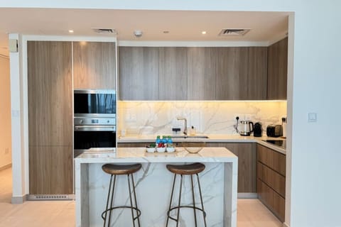 A luxurious kitchen designed for both cooking and entertaining, featuring top-of-the-line appliances and sleek finishes.