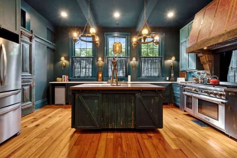 Rustic wood floors meet modern stainless-steel appliances—everything you need for cooking at home.