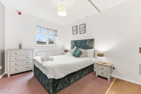 Comfortable bedroom with hotel-style bedding.