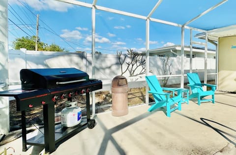 Screened-in pool, a BBQ, cocktail bar area, outdoor furniture, corn hole boards