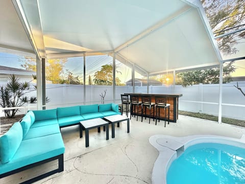 Screened-in pool, a BBQ, cocktail bar area, outdoor furniture, corn hole boards