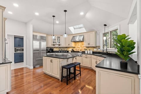 Fully stocked chef’s kitchen with bar seating — cook, gather, and connect