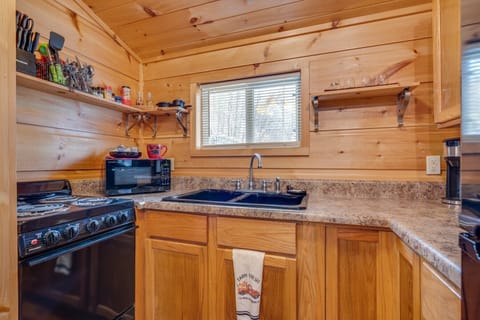 Refrigerator, range, microwave, and coffee maker are included among other items.