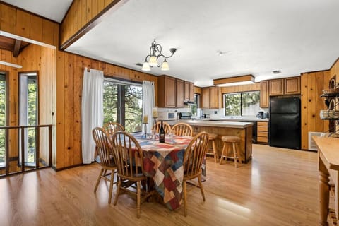 Large Open Great Room (Living Room / Kitchen / Dining) with Wood Burning River Rock Fireplace and Spacious Wrap Around Covered Deck!