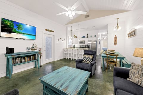 Relax in your coastal-themed living space with comfy seating, weathered turquoise furnishings, and nautical touches that create the perfect beach house atmosphere.