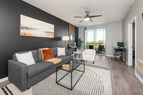 Stylish living room with comfortable double sofa bed, working station and private patio.
