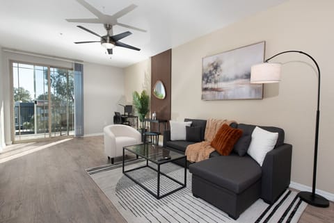 Stylish living room with comfortable double sofa bed, working station and private patio.
