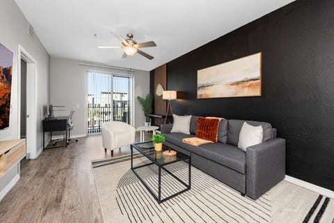 Stylish living room with comfortable double sofa bed, working station and private patio.