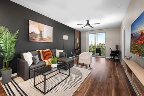 Stylish living room with comfortable double sofa bed, working station and private patio.