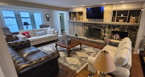 a cozy room for all to hang out with a real fireplace and big screen hi-def tv