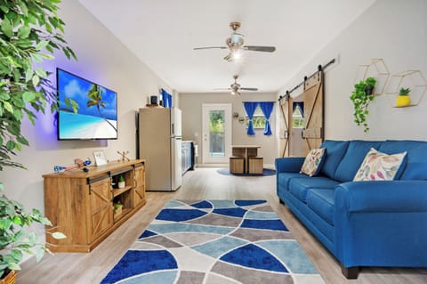 The vibrant living space with a wall mounted Smart TV and plush sofa 