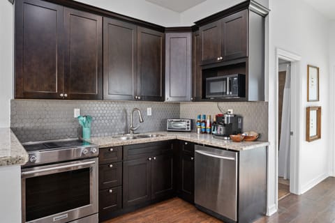 Contemporary and well-equipped kitchen with sleek countertops, ample storage, and all the essentials to make meal preparation a breeze during your stay.