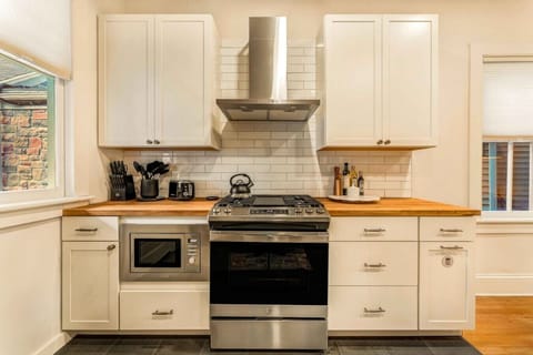 Fully equipped kitchen featuring a large fridge, oven, and stove—perfect for preparing your favorite meals during your stay.
