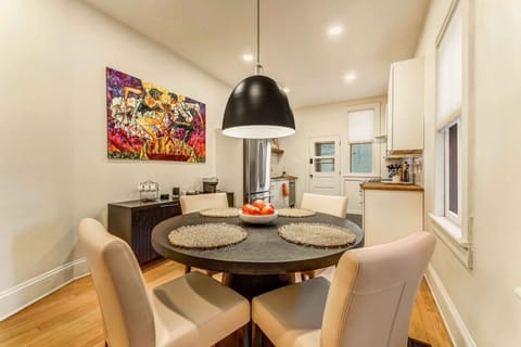 An additional dining table for 4 is conveniently located in the kitchen area of Unit 1, offering extra seating for meals, snacks, or a cozy spot to gather while preparing food.