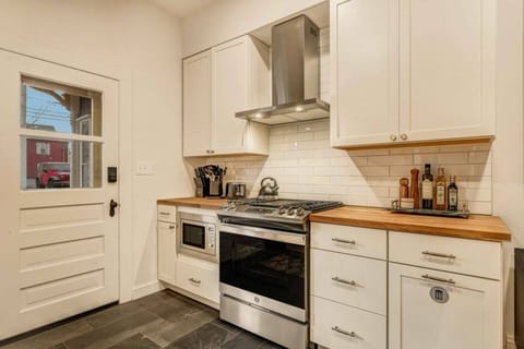 Cook your favorite meals with ease using the modern stove and oven, ready for all your culinary creations.