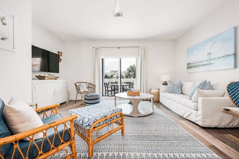 Living room with queen sleeper sofa, smart TV and balcony with dining table