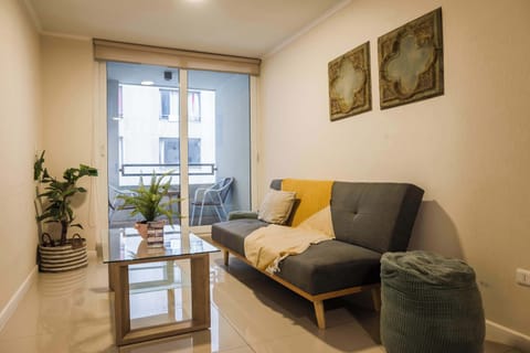 Cozy living area with balcony access, perfect for relaxing after exploring the city.