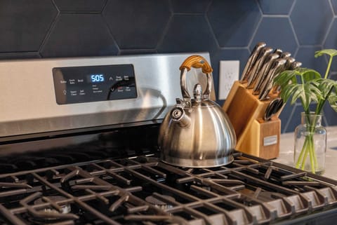 The sleek, open kitchen offers ample space & every home comfort