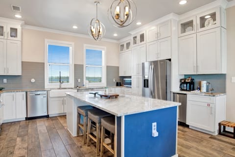 The stunning kitchen is fully equipped and has stone counters and stainless appliances