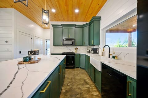 The chic, open kitchen offers ample space & all the comforts of home